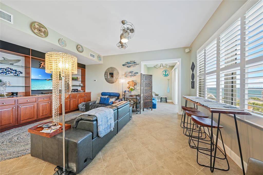 2590 North Beach Road, Unit 5 Englewood, FL 34223 - Photo 11 of 45 a living room with furniture and a large window