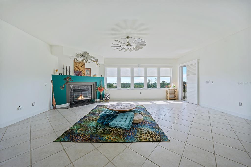 2590 North Beach Road, Unit 5 Englewood, FL 34223 - Photo 14 of 45 an outdoor space with lots of furniture and a fireplace