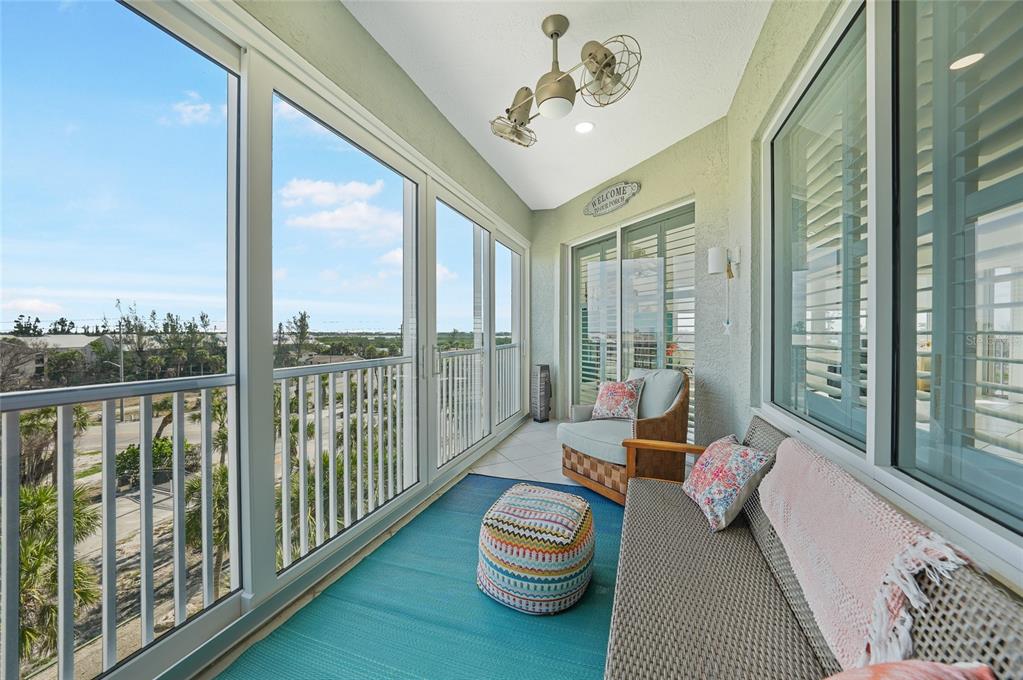 2590 North Beach Road, Unit 5 Englewood, FL 34223 - Photo 18 of 45 a living room with furniture and a floor to ceiling window