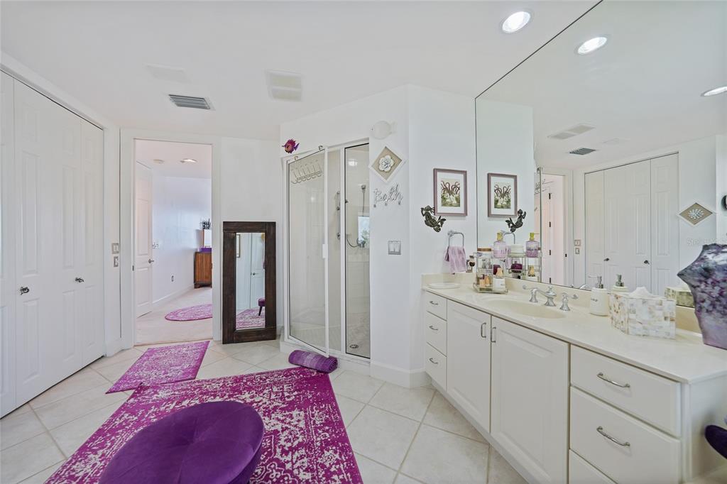 2590 North Beach Road, Unit 5 Englewood, FL 34223 - Photo 21 of 45 a spacious bathroom with a double vanity sink mirror and shower