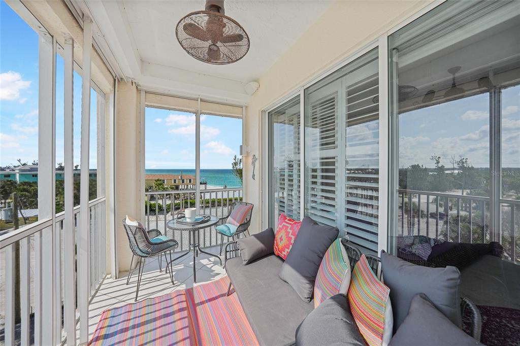 2590 North Beach Road, Unit 5 Englewood, FL 34223 - Photo 23 of 45 a living room with furniture and a floor to ceiling window