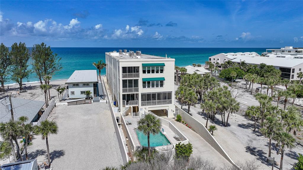 2590 North Beach Road, Unit 5 Englewood, FL 34223 - Photo 24 of 45 a view of a balcony with chairs and potted plants
