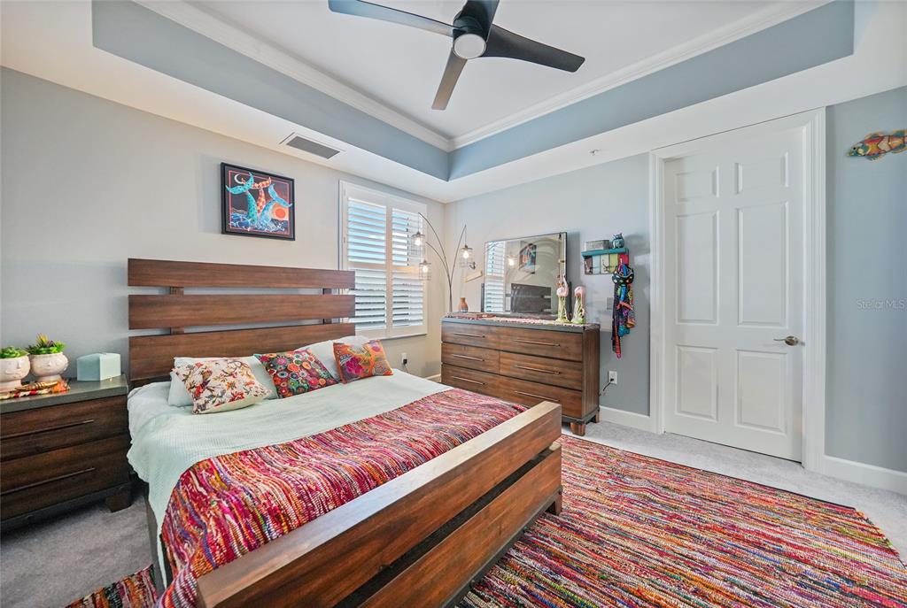 2590 North Beach Road, Unit 5 Englewood, FL 34223 - Photo 28 of 45 a bedroom with a bed and a chandelier