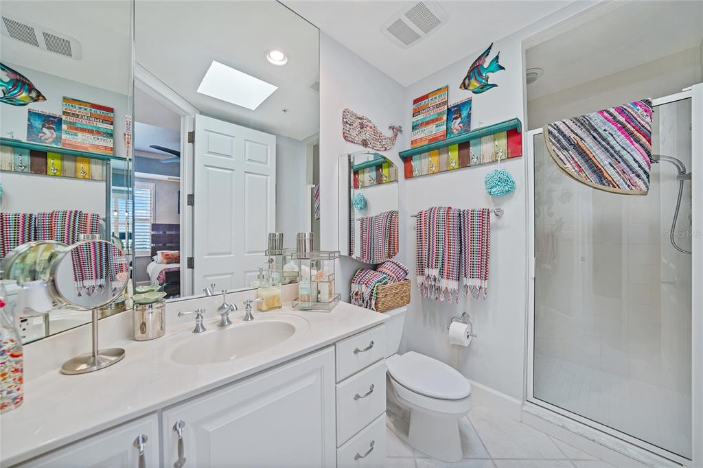 2590 North Beach Road, Unit 5 Englewood, FL 34223 - Photo 30 of 45 a bathroom with a sink toilet and shower