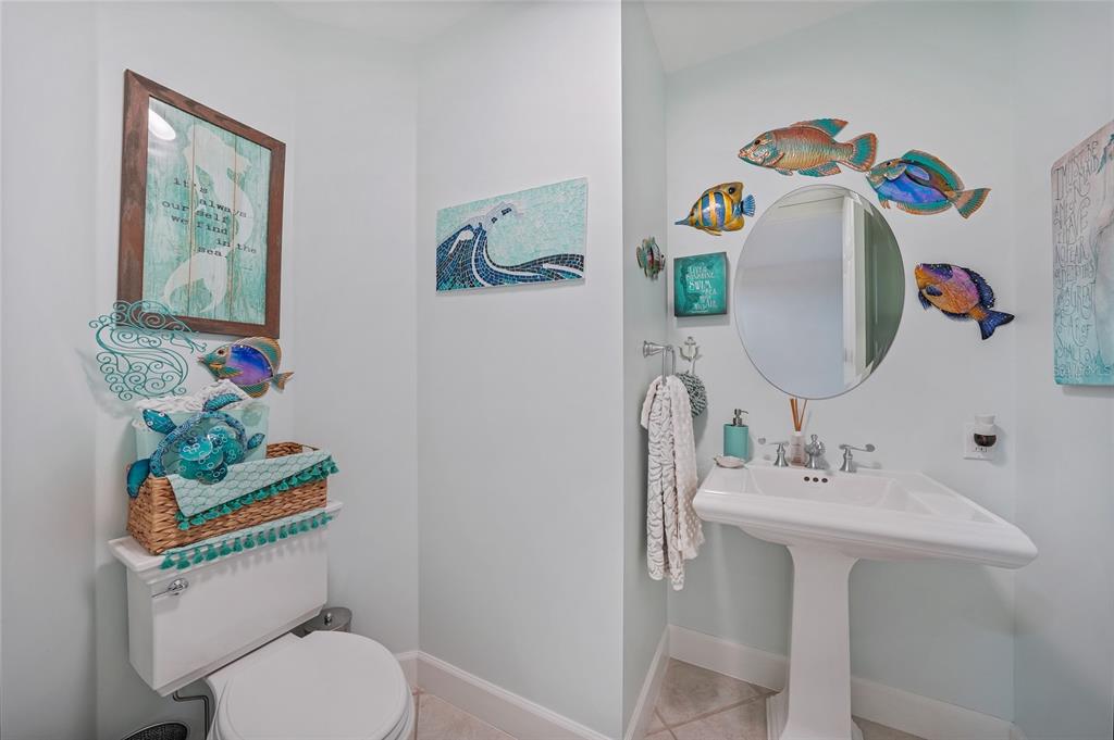 2590 North Beach Road, Unit 5 Englewood, FL 34223 - Photo 31 of 45 a bathroom with a sink mirror and toilet