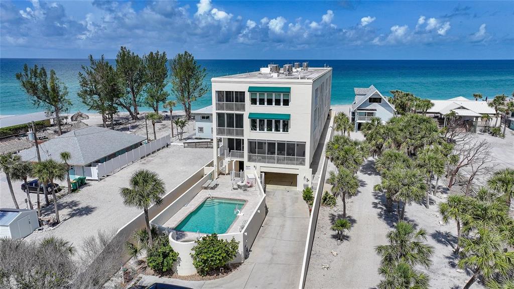 2590 North Beach Road, Unit 5 Englewood, FL 34223 - Photo 32 of 45 an aerial view of a house with a yard and lake view