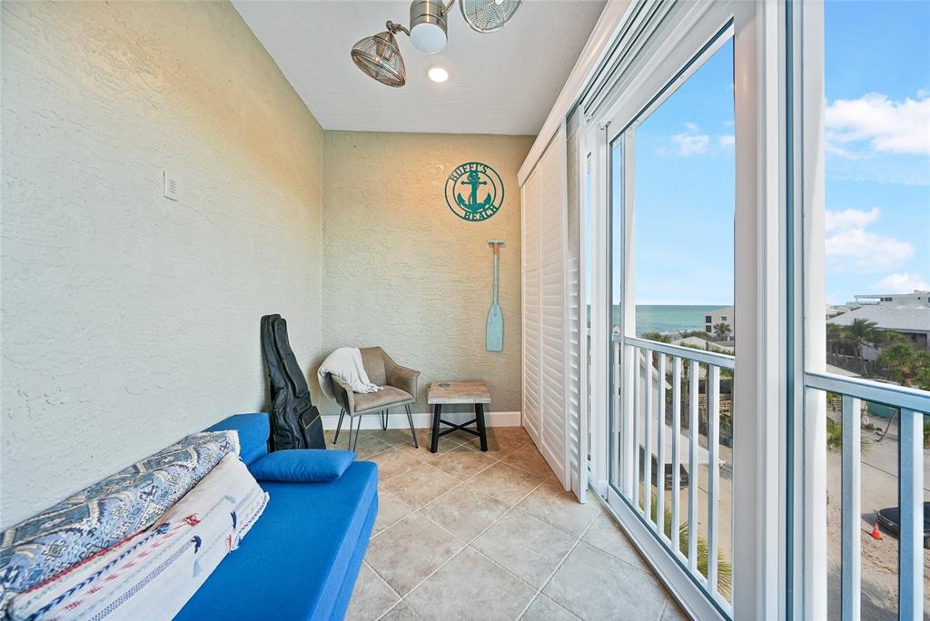 2590 North Beach Road, Unit 5 Englewood, FL 34223 - Photo 43 of 45 a view of a hallway with couch and chairs
