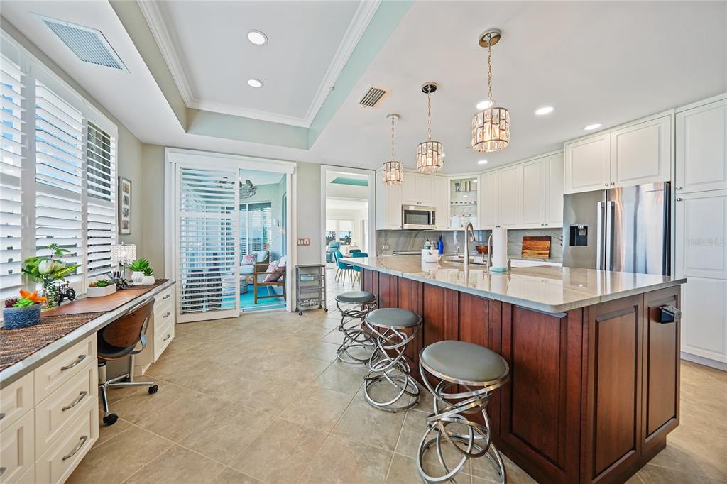 2590 North Beach Road, Unit 5 Englewood, FL 34223 - Photo 9 of 45 a room with stainless steel appliances kitchen island granite countertop furniture a refrigerator and a wooden fence
