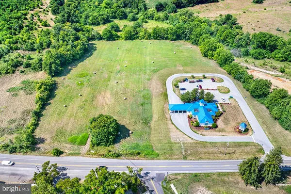 an aerial view of a swimming pool with an outdoor space