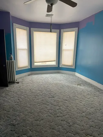 a view of room with window and a ceiling fan