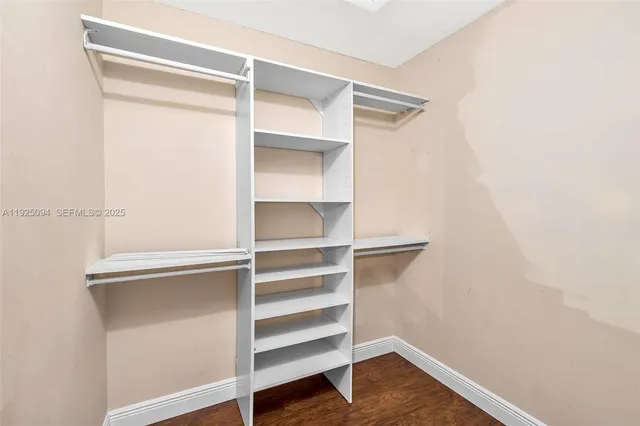 a view of walk in closet with empty racks