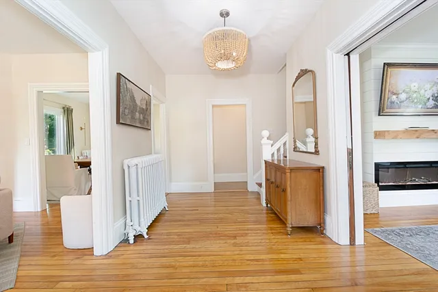 a view of a living room and kitchen with wooden floor