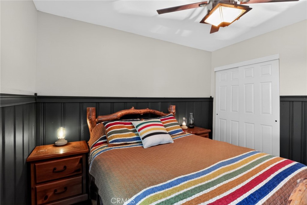 2775 View Running Springs, CA 92382 - Photo 17 of 30 a bedroom with a bed and lamp