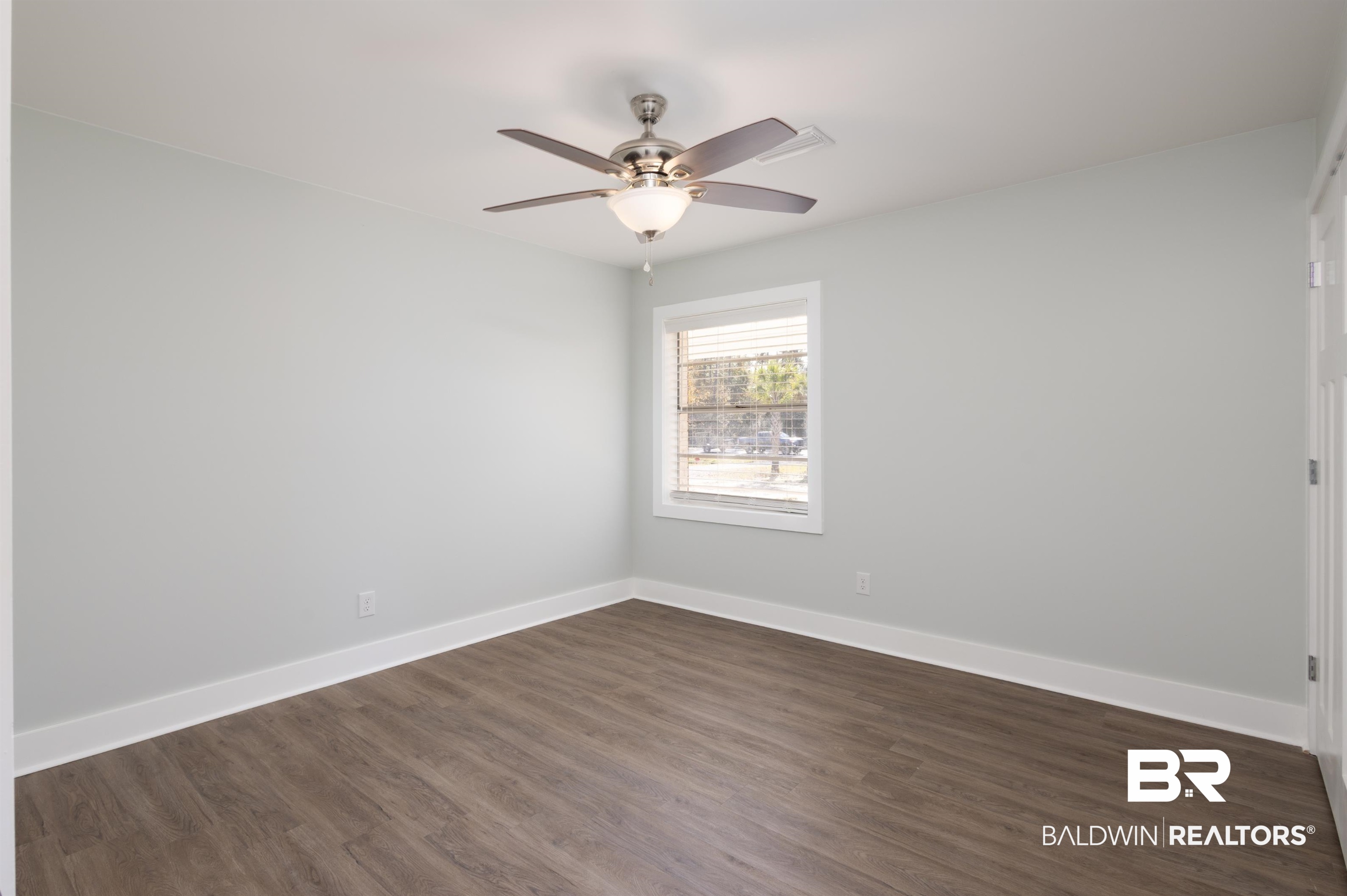 18267 Highway 98 Foley, AL 36535 - Photo 14 of 26 Empty room with dark wood-style floors and ceiling fan