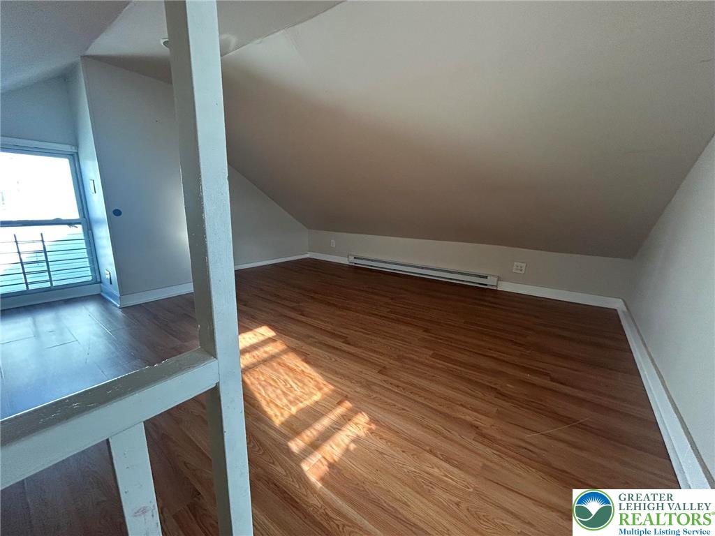 1122 East 4th Street Bethlehem, PA 18015 - Photo 12 of 13 Sloping ceilings and sun-drenched wood flooring define this versatile attic space.