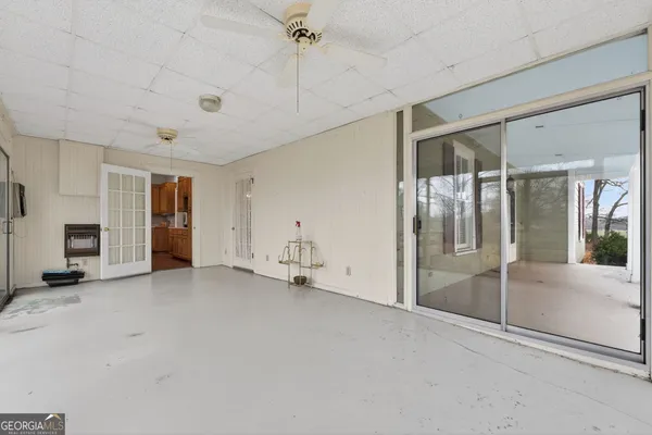 a kitchen with a stove a sink a window and cabinetry