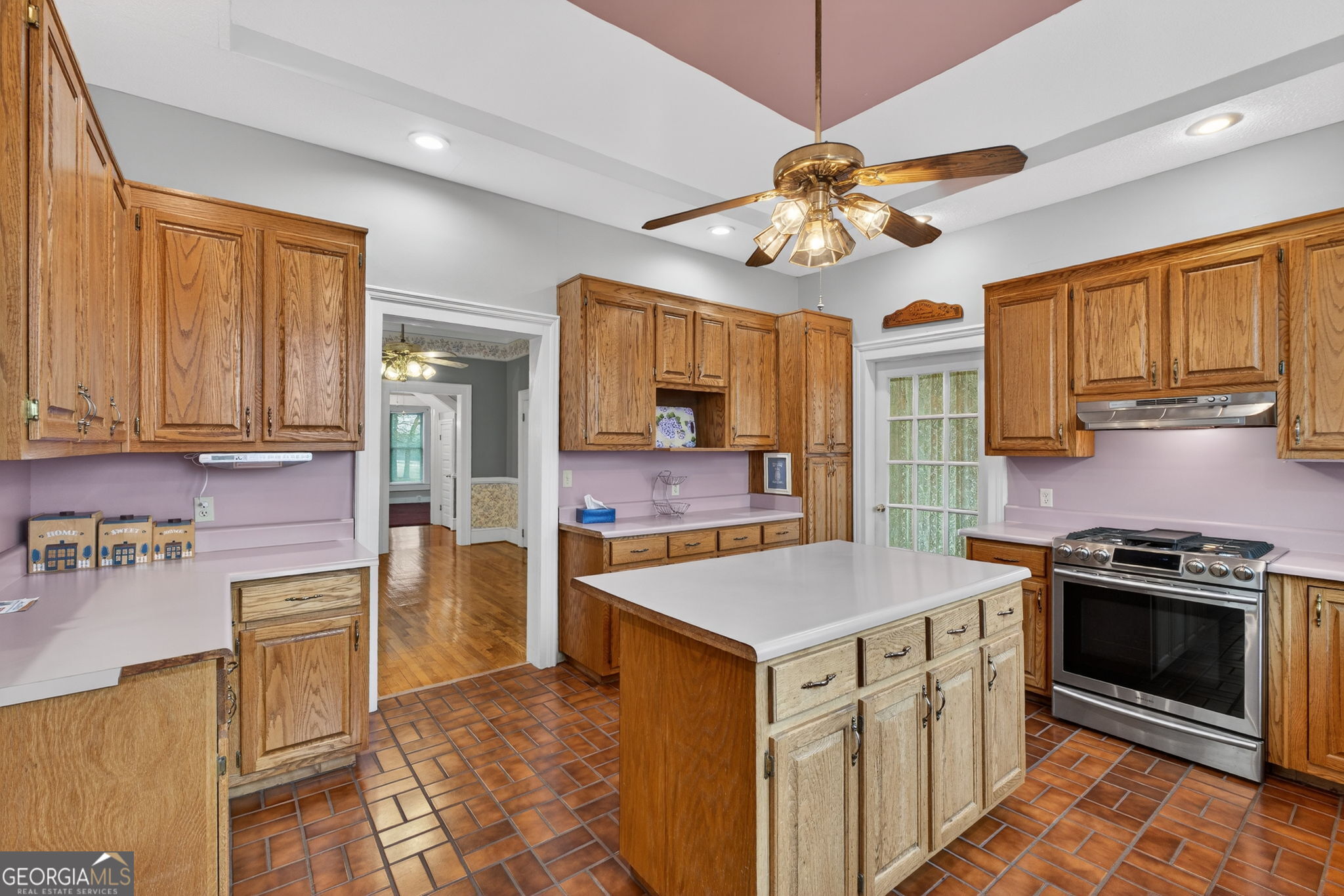 402 Tom Bell Road Milner, GA 30257 - Photo 21 of 75 a kitchen with a stove a sink and a refrigerator