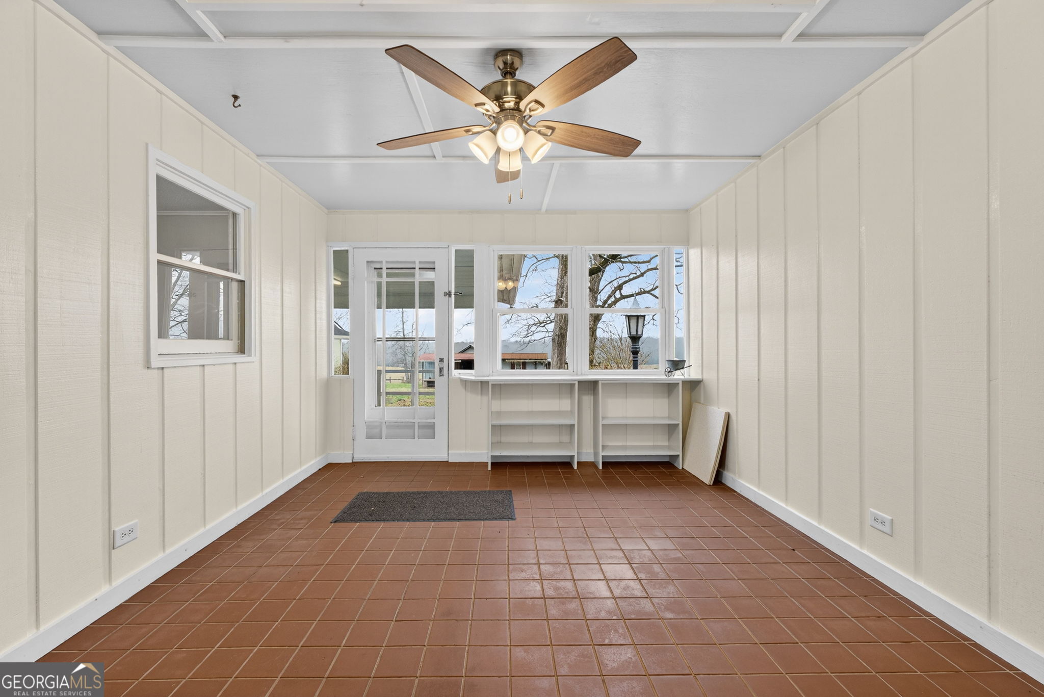 402 Tom Bell Road Milner, GA 30257 - Photo 24 of 75 a room with chandelier fan and wooden floor