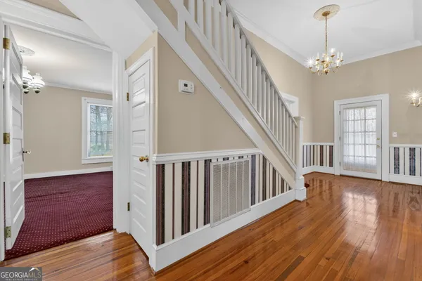a view of a house with a yard and sitting area