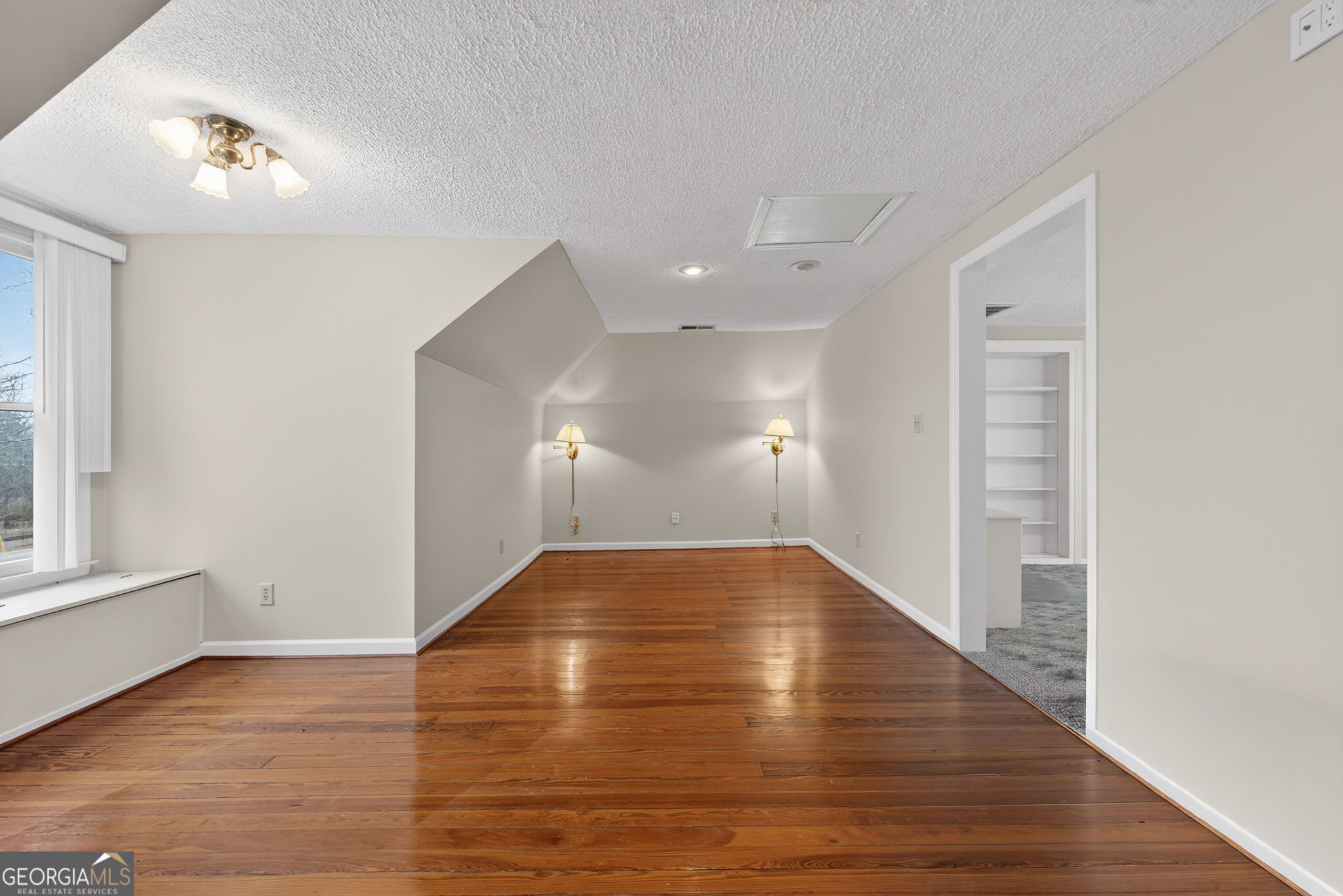 402 Tom Bell Road Milner, GA 30257 - Photo 40 of 75 a view of empty room with wooden floor