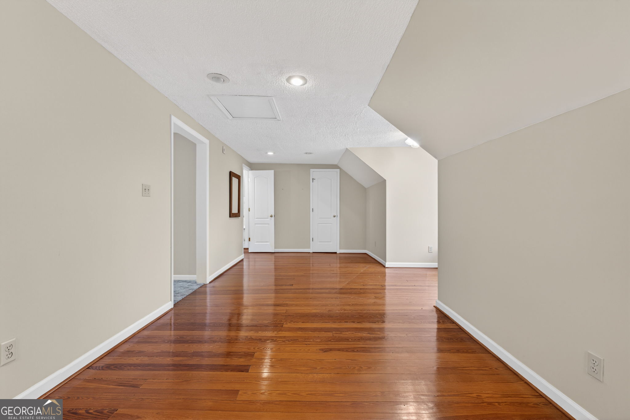 402 Tom Bell Road Milner, GA 30257 - Photo 41 of 75 a view of an empty room and wooden floor
