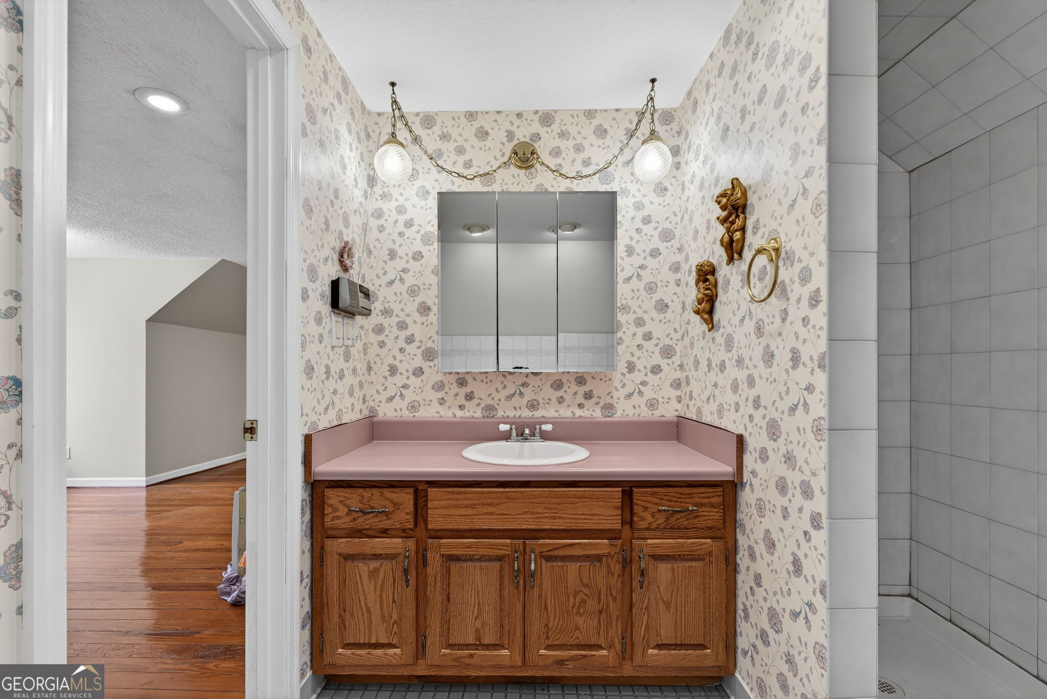 402 Tom Bell Road Milner, GA 30257 - Photo 44 of 75 a bathroom with a sink and a mirror