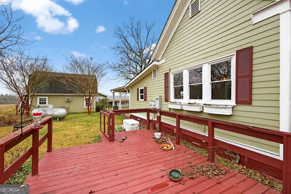 a backyard of a house with a yard and trampoline