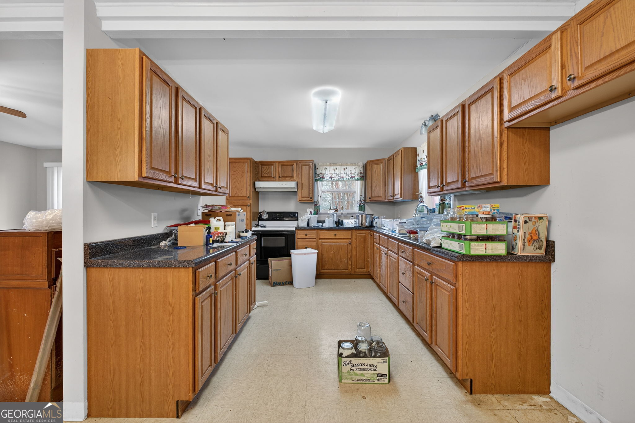 402 Tom Bell Road Milner, GA 30257 - Photo 55 of 75 a kitchen with granite countertop a sink dishwasher stove top oven and cabinets