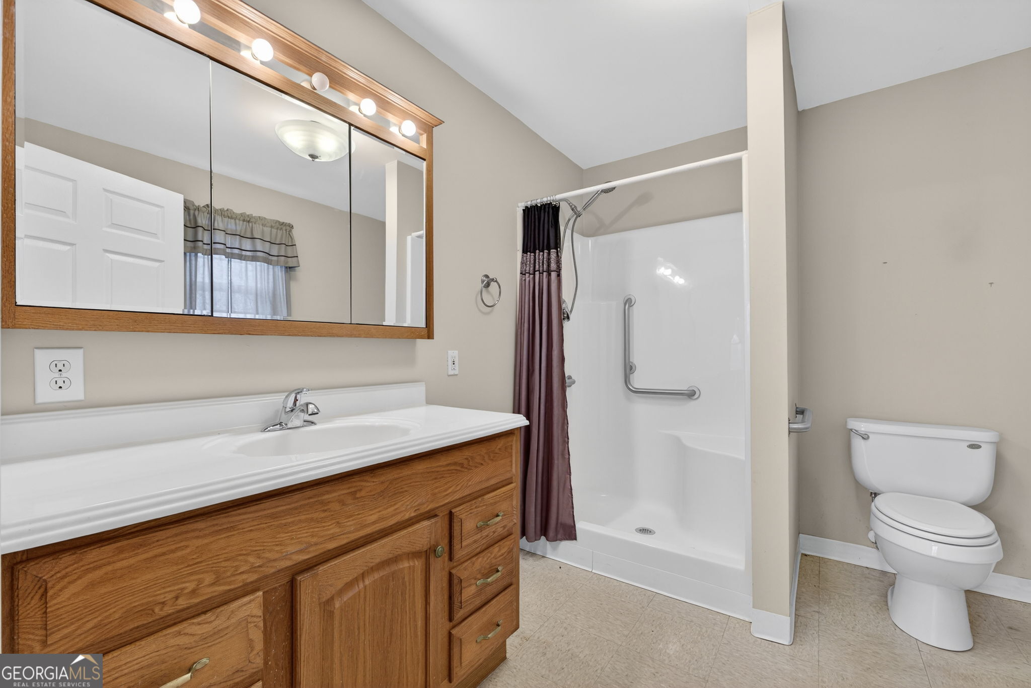 402 Tom Bell Road Milner, GA 30257 - Photo 59 of 75 a bathroom with a sink a toilet and shower