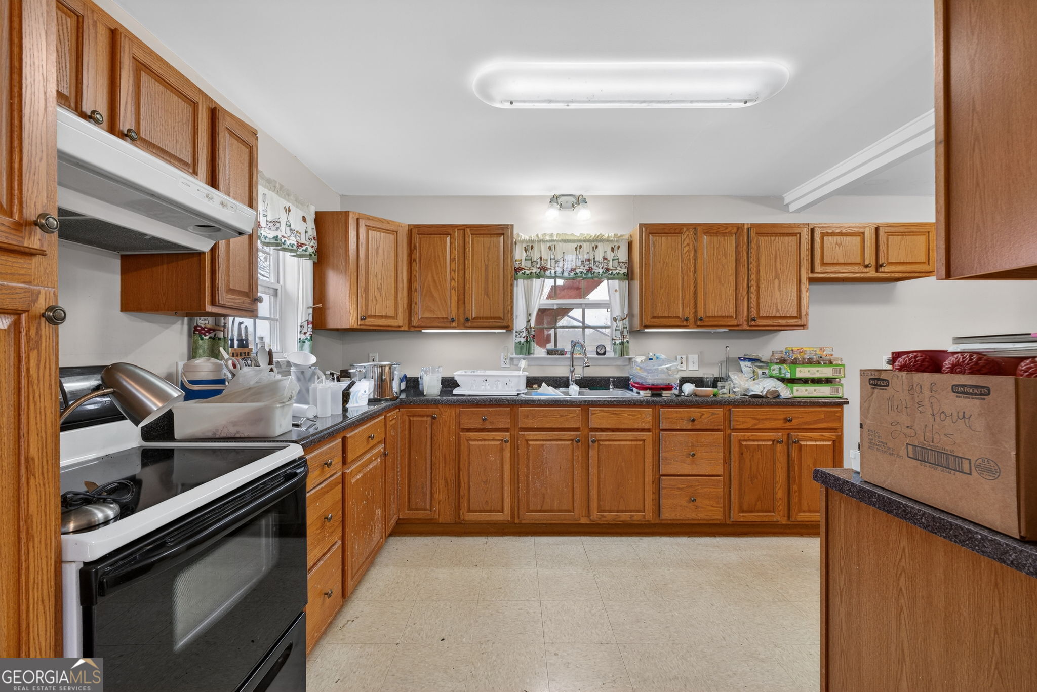 402 Tom Bell Road Milner, GA 30257 - Photo 60 of 75 a kitchen with stainless steel appliances granite countertop a sink stove and cabinets