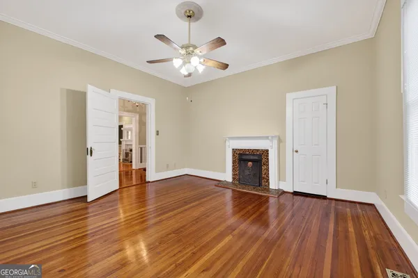 a view of an empty room and wooden floor