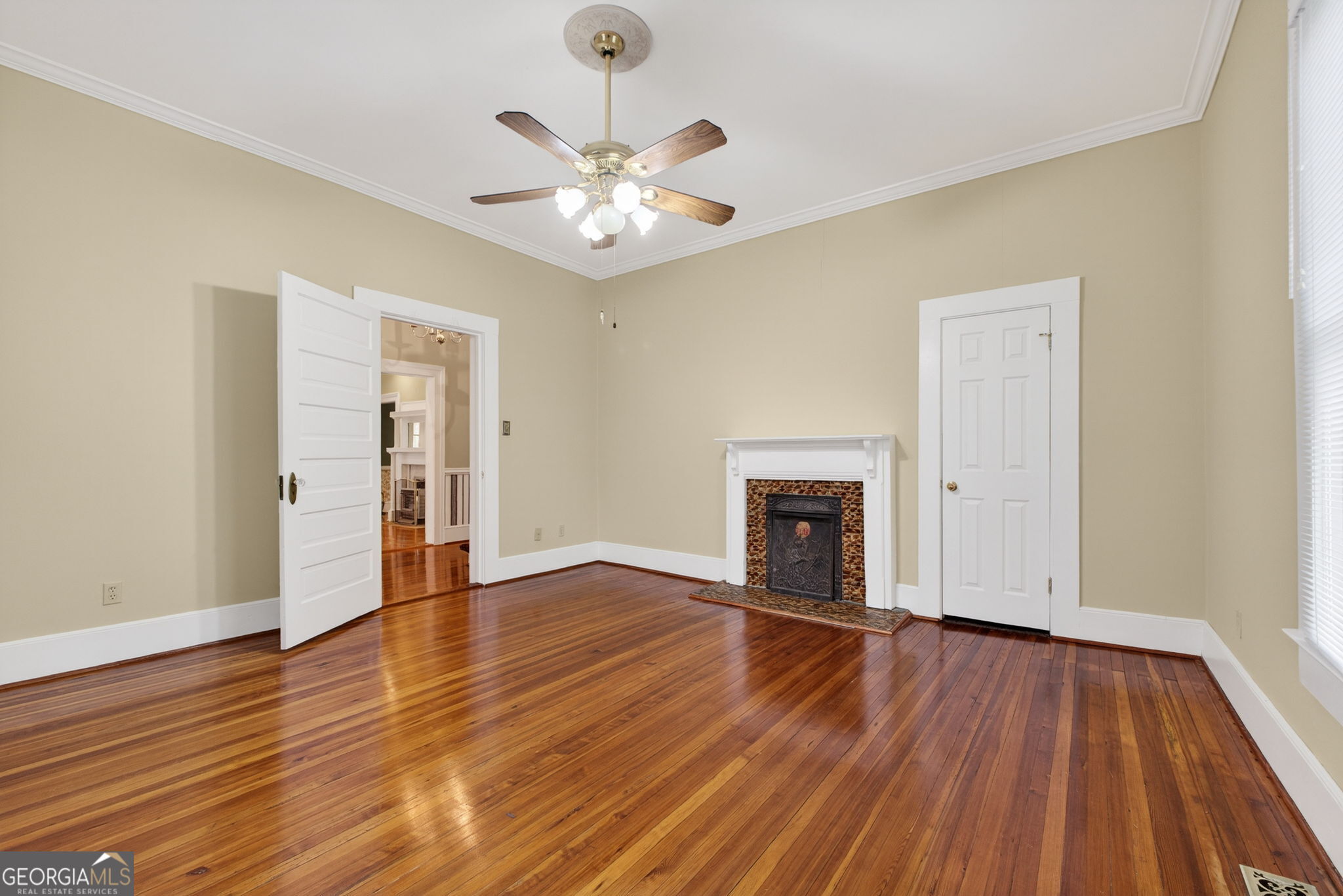 402 Tom Bell Road Milner, GA 30257 - Photo 9 of 75 an empty room with wooden floor fireplace and windows