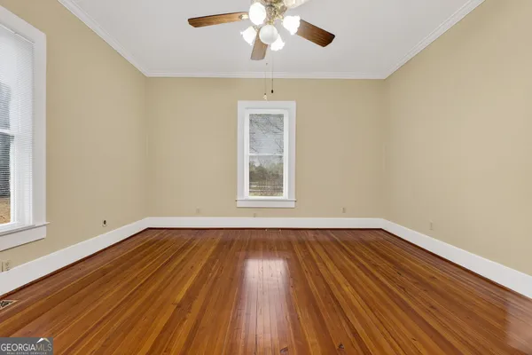 a view of an empty room with a fireplace and a window