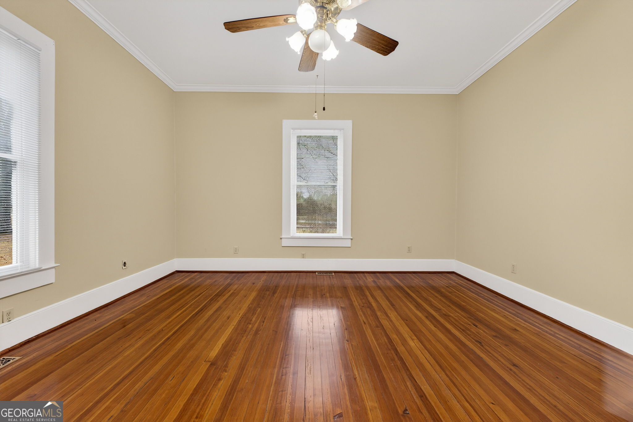 402 Tom Bell Road Milner, GA 30257 - Photo 10 of 75 a view of an empty room with wooden floor and a window
