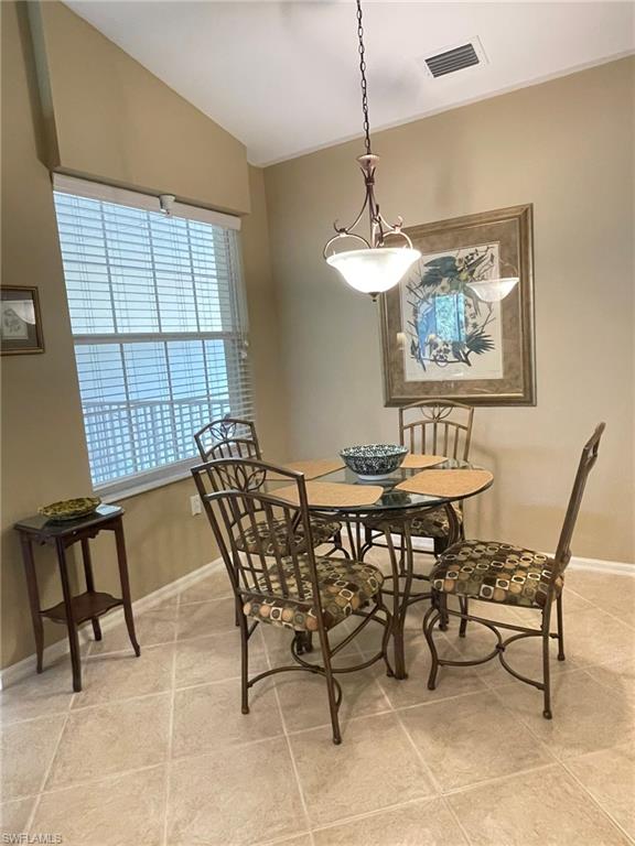 8165 Celeste Drive, Unit 2228 Naples, FL 34113 - Photo 11 of 30 a view of a dining room that has a table and chairs