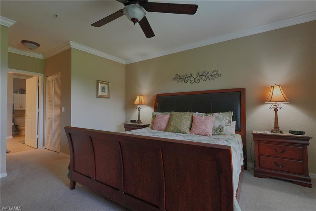 8165 Celeste Drive, Unit 2228 Naples, FL 34113 - Photo 16 of 30 a bedroom with a bed and a night stand