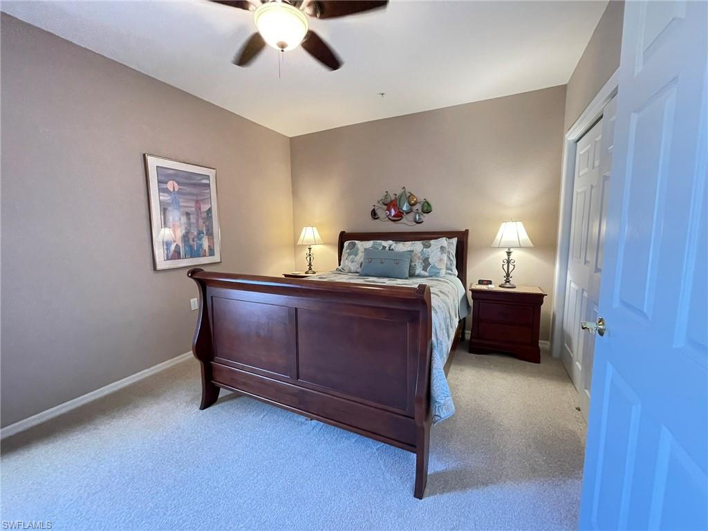 8165 Celeste Drive, Unit 2228 Naples, FL 34113 - Photo 19 of 30 a bed room with a bed and a window