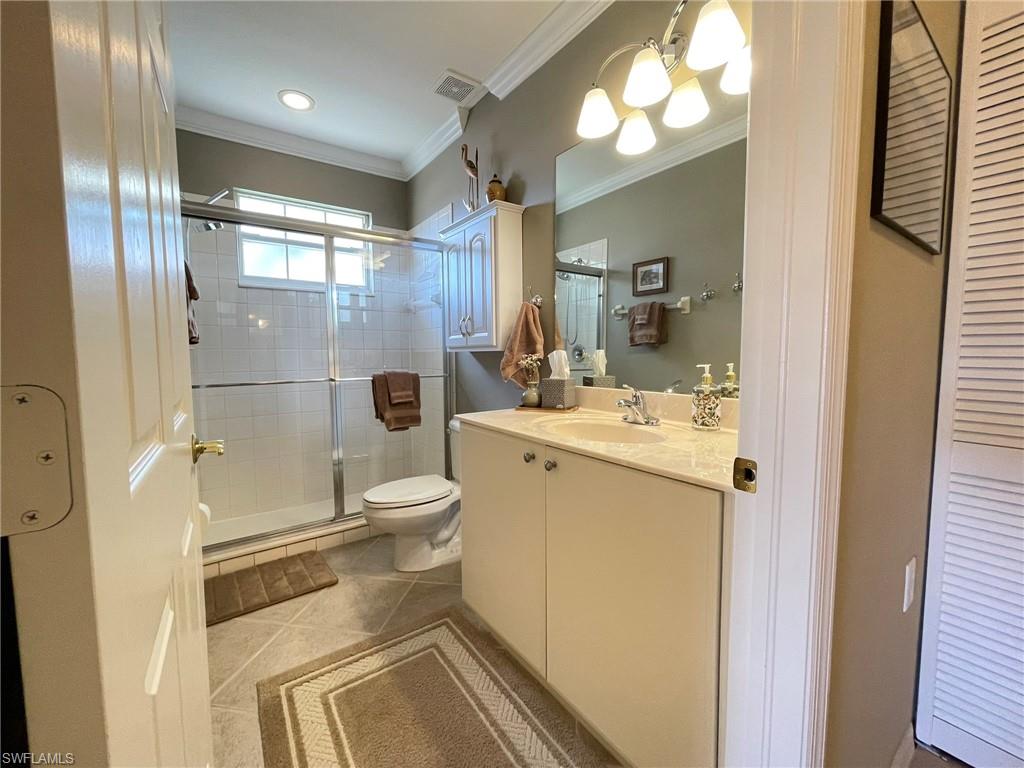 8165 Celeste Drive, Unit 2228 Naples, FL 34113 - Photo 22 of 30 a bathroom with a sink a toilet and shower