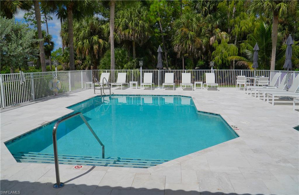 8165 Celeste Drive, Unit 2228 Naples, FL 34113 - Photo 28 of 30 a view of a swimming pool with a patio