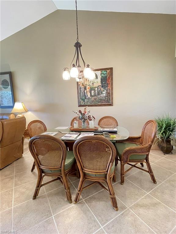8165 Celeste Drive, Unit 2228 Naples, FL 34113 - Photo 10 of 30 a dining room with furniture and chandelier