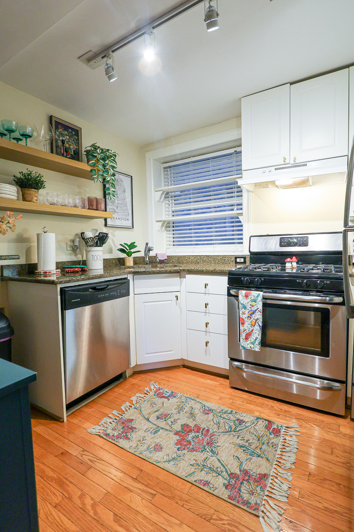 616 Michigan Avenue, Unit G Evanston, IL 60202 - Photo 6 of 20 a kitchen with stainless steel appliances granite countertop a sink stove and refrigerator