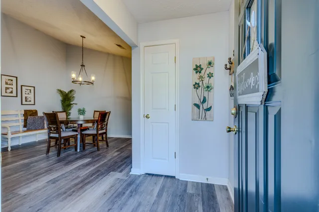 a view of a dining room with furniture and wooden floor