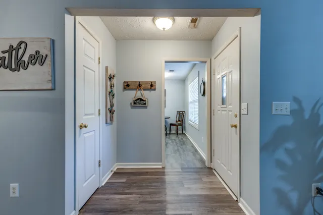 a view of a hallway with a wooden floor