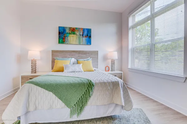 a bedroom with a bed and window