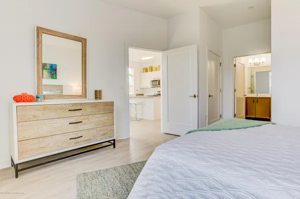 a bedroom with a bed and a dresser