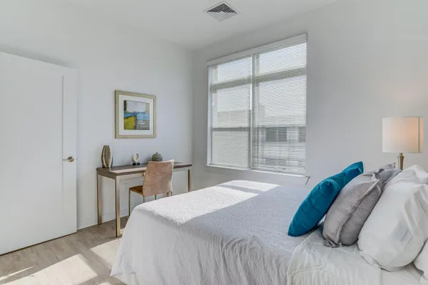 a bedroom with a bed and a window