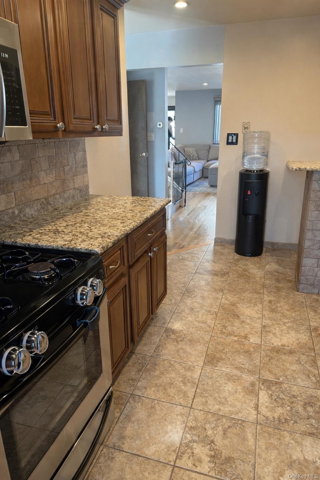 88 East Valley Stream Boulevard, Unit 9 Valley Stream, NY 11580 - Photo 8 of 17 a kitchen with a stove and a refrigerator