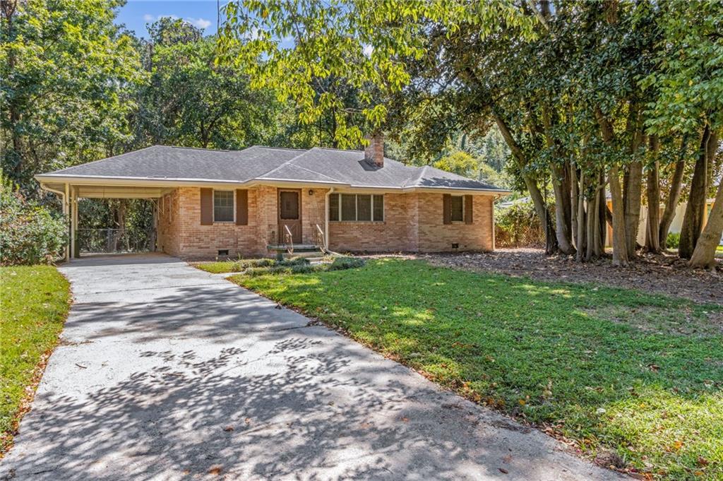 4245 Rickenbacker Way Northeast Atlanta, GA 30342 - Photo 1 of 1 a front view of a house with a garden