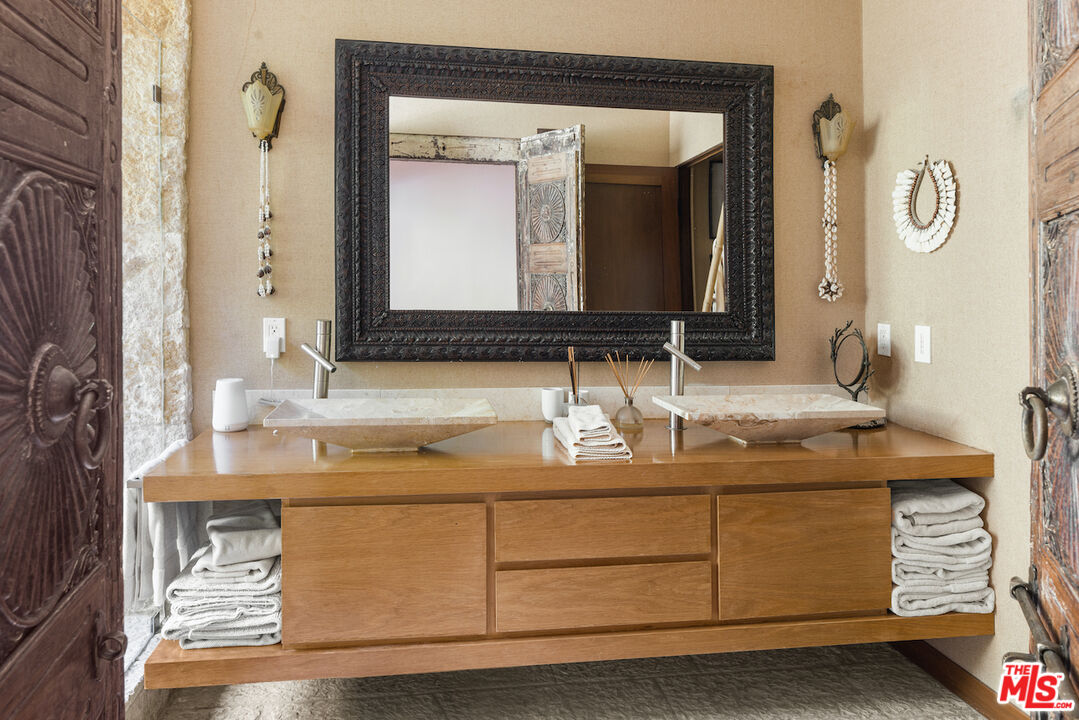 473 West Rustic Road Santa Monica, CA 90402 - Photo 12 of 25 a bathroom with a sink vanity and a mirror