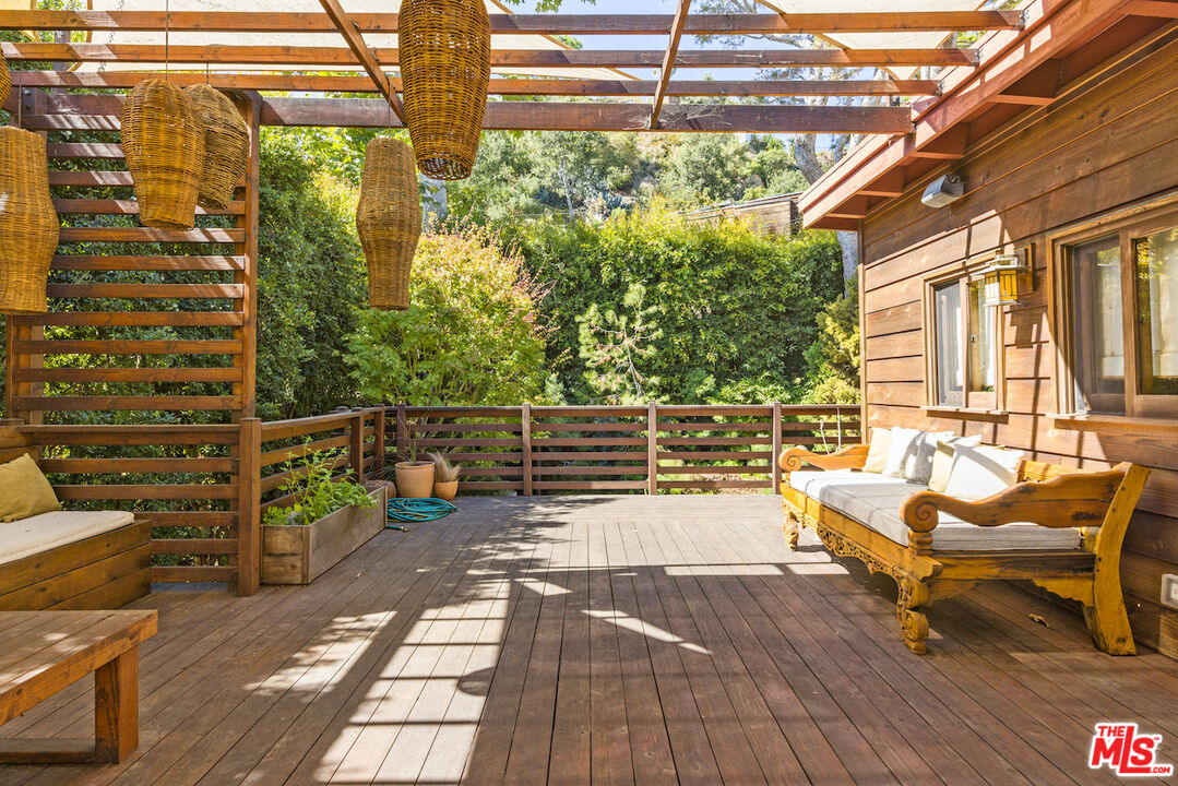 473 West Rustic Road Santa Monica, CA 90402 - Photo 21 of 25 a balcony with wooden floor and outdoor seating